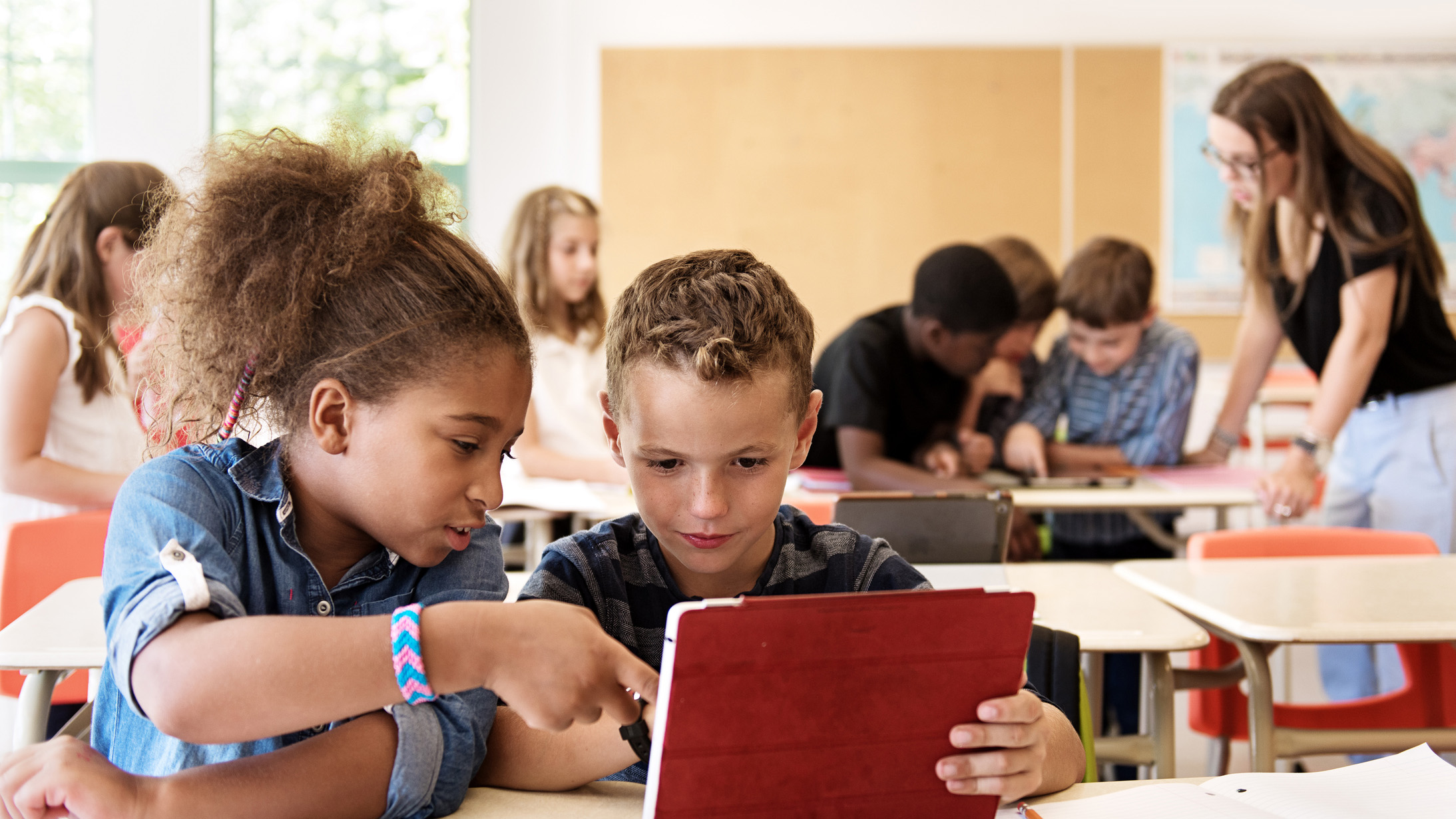 Two kids using a tablet