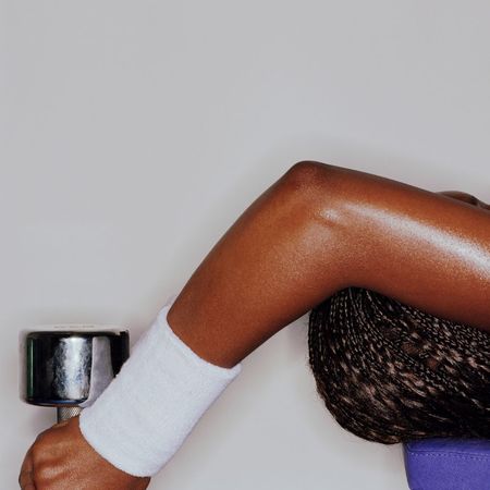 A woman lifting weights in the gym