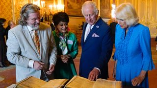 King Charles and Queen Camilla are shown a first and second folio of works by William Shakespeare