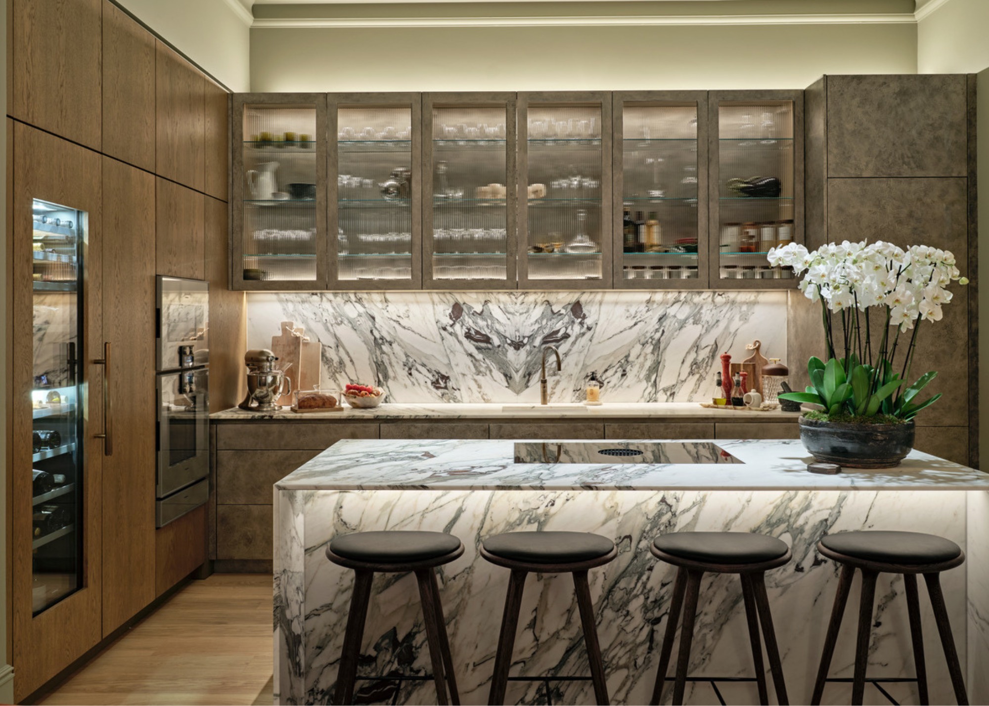 beautiful quartzite kitchen with matching counters to backsplash and wooden cabinets with glass fronts