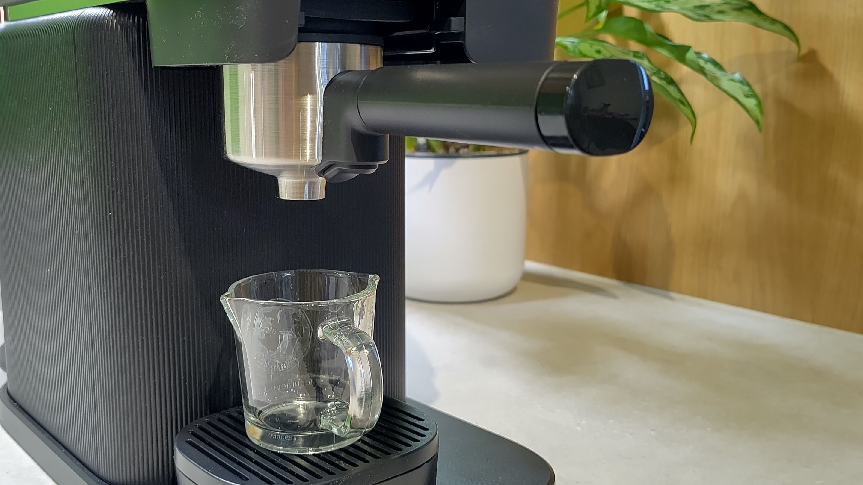 Philips Baristina espresso machine preparing to dispense espresso