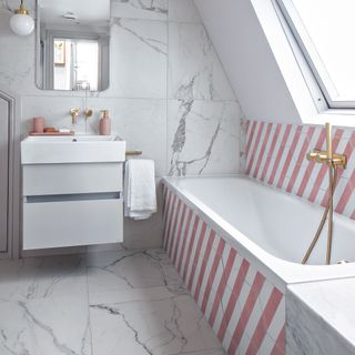 Pink and white striped tiles on bath