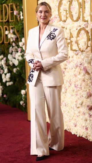 Kate Winslet wears a white suit for the 82nd Annual Golden Globes held at The Beverly Hilton on January 05, 2025 in Beverly Hills