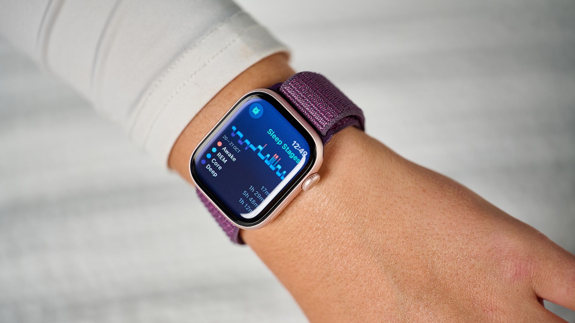 The Apple Watch 10 with a purple strap displaying sleep stages screen on the wrist of our sleep tech tester 
