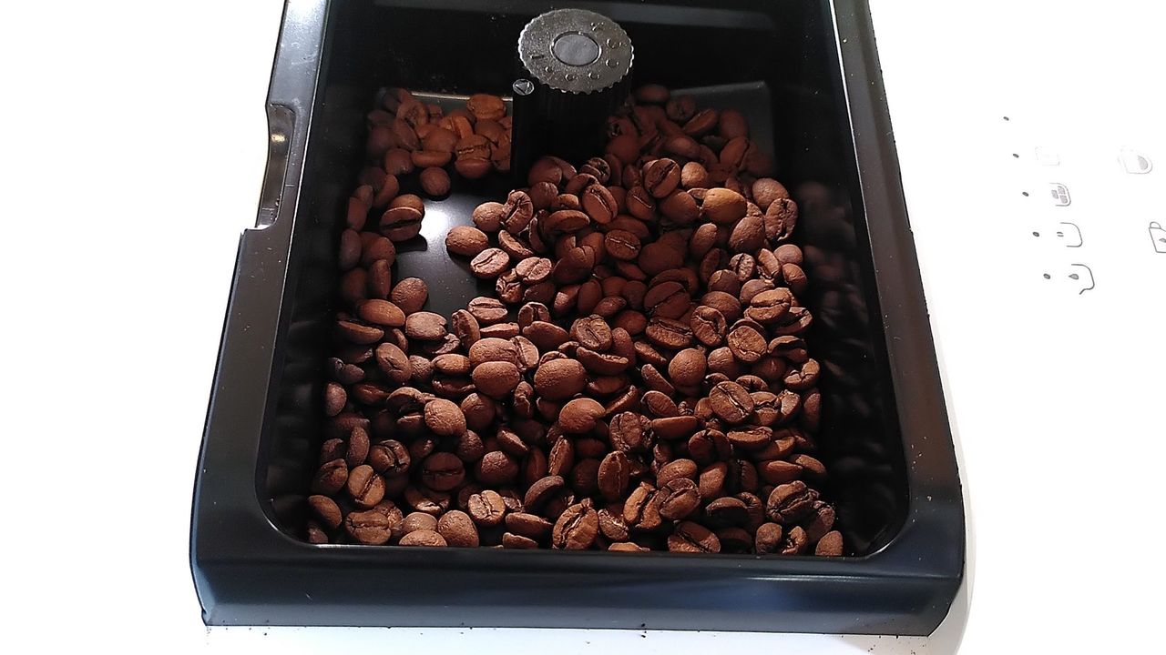Coffee beans in hopper of Smeg BCC13 coffee maker