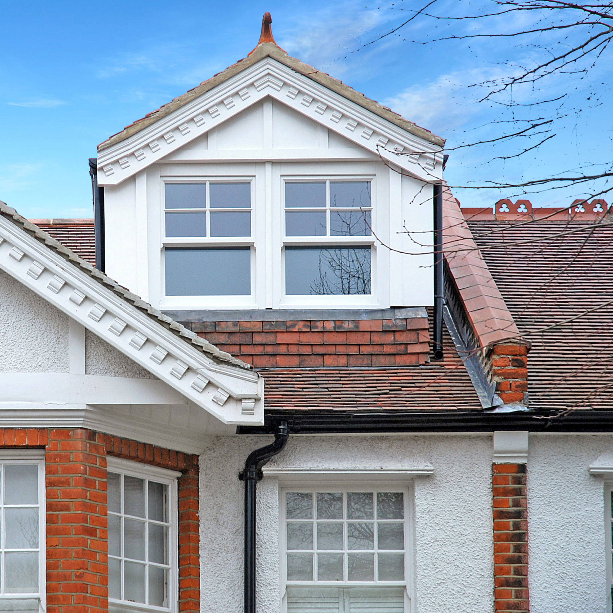 dormer loft conversion with clay roof tiles and sash windows
