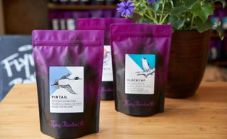 Flying Roasters coffee in purlple and black packets