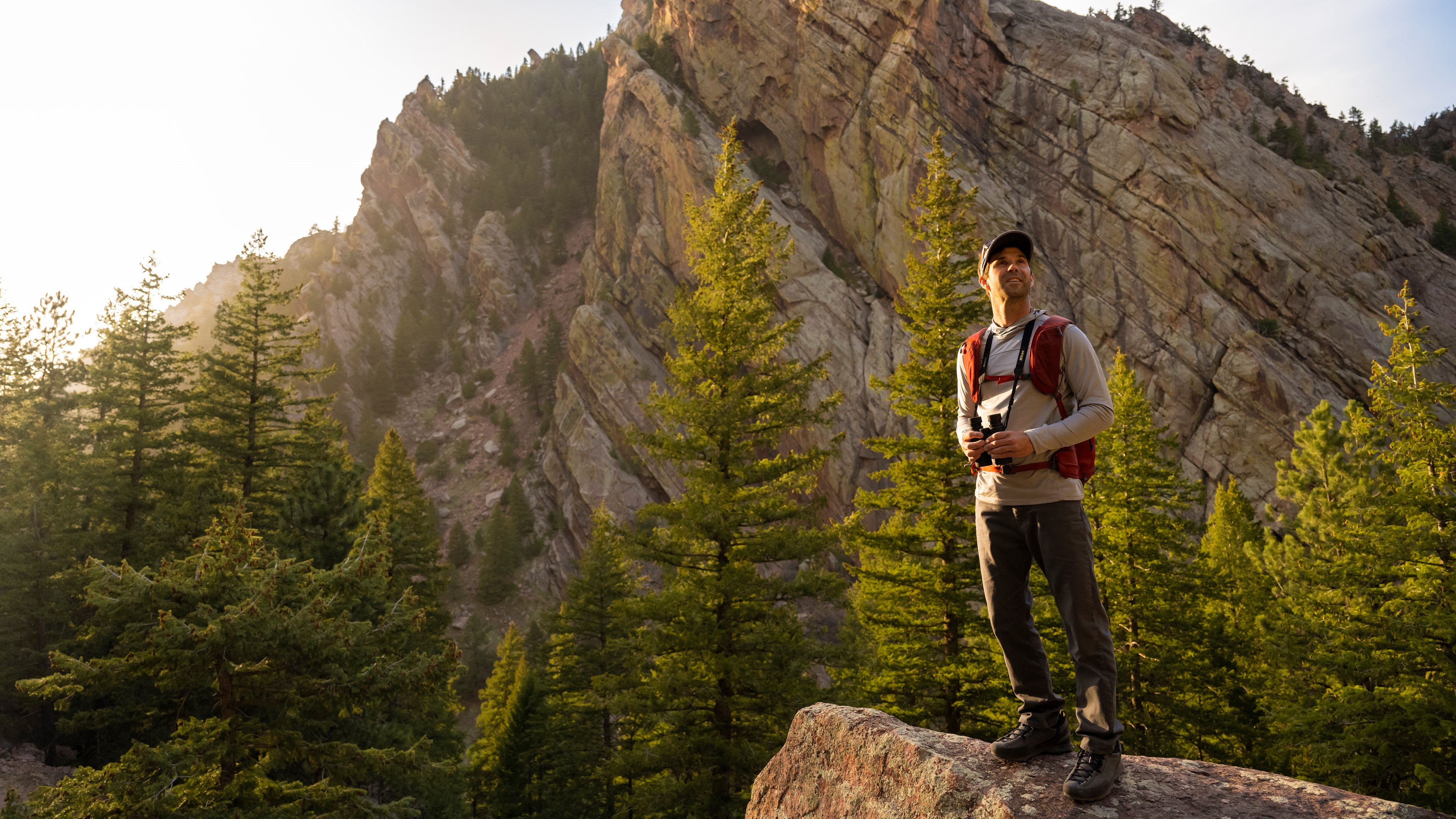 Man using Nikon Prostaff binoculars on a mountain