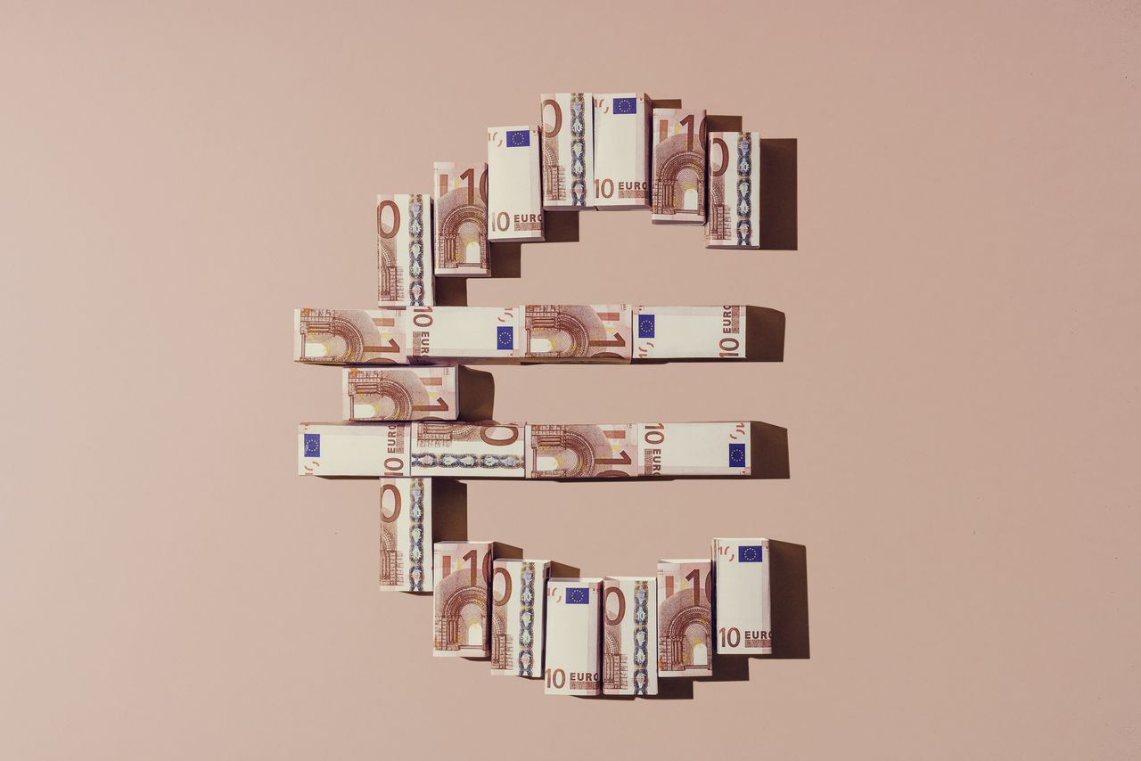 Folded euro notes making a shape of the euro currency sign indicating European stocks