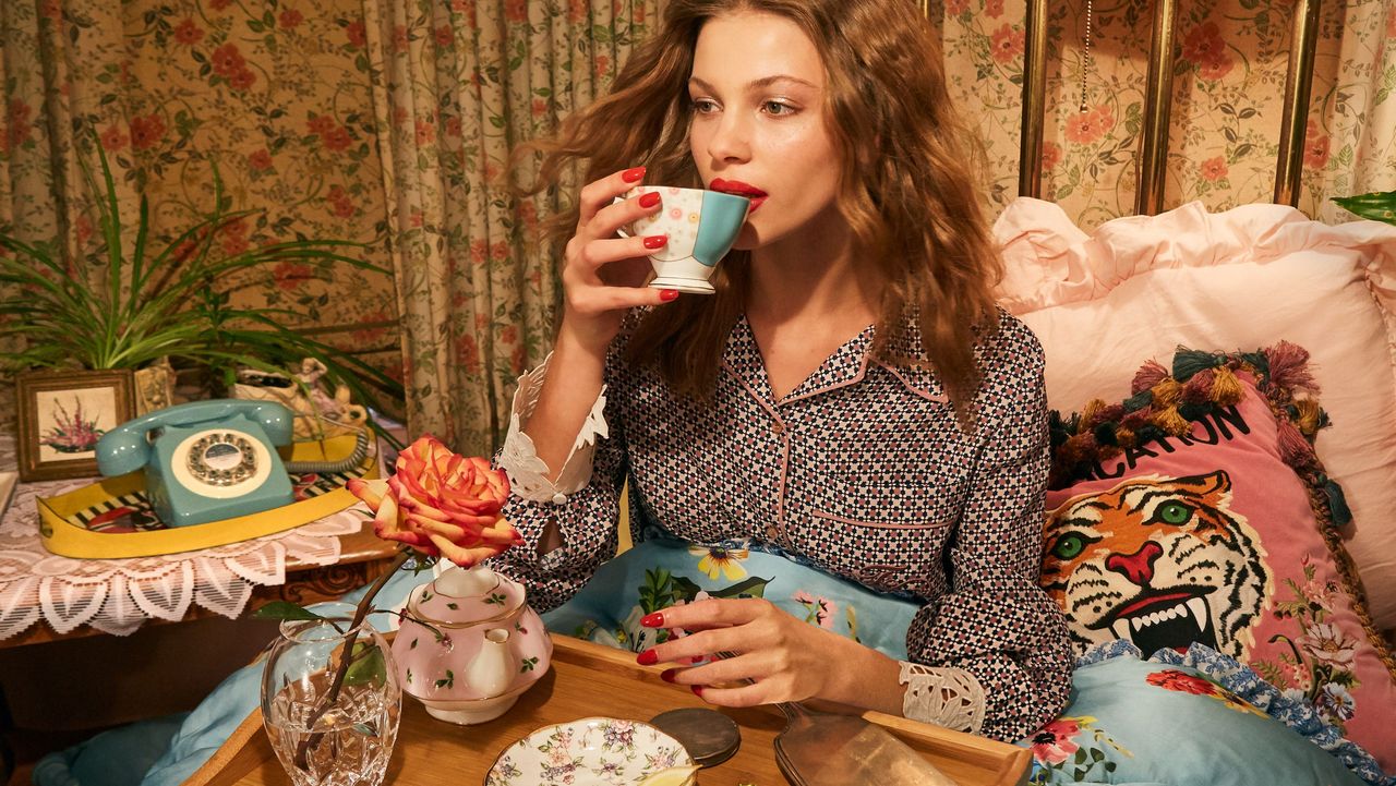 model lounging in summer pajamas in bed with a plate