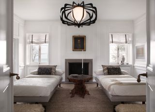 spare bedroom with two wrought iron bed and white walls