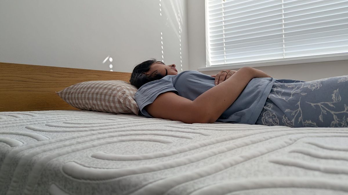 Our tester lying in the front, back and side positions to assess the comfort and support of the mattress