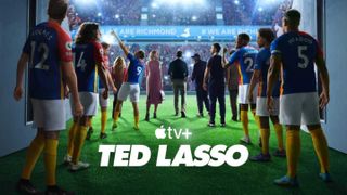 A team of players walking onto a football pitch with Apple TV Plus logo and Ted Lasso written in white underneath