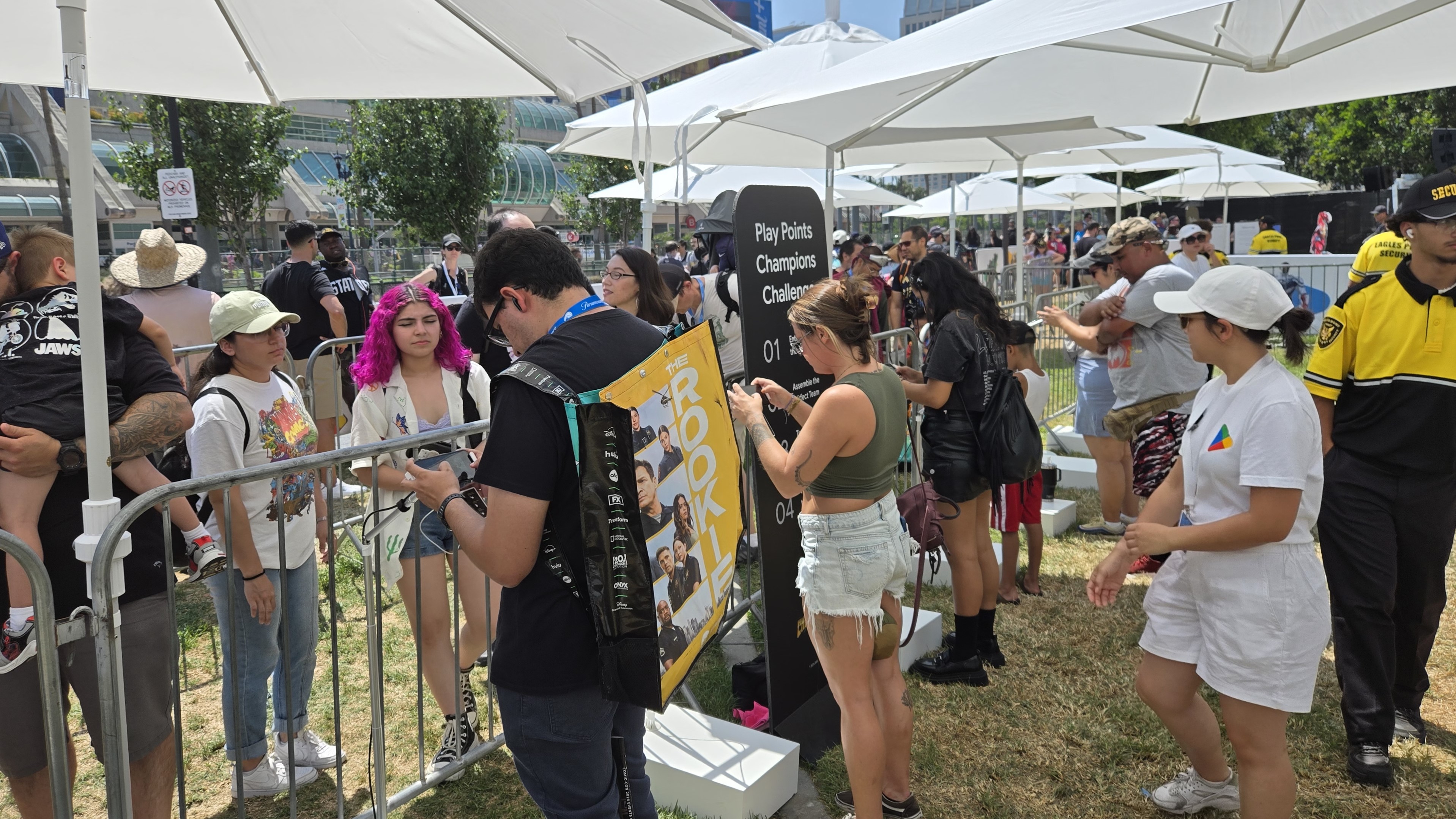 People playing games on phones while waiting in line