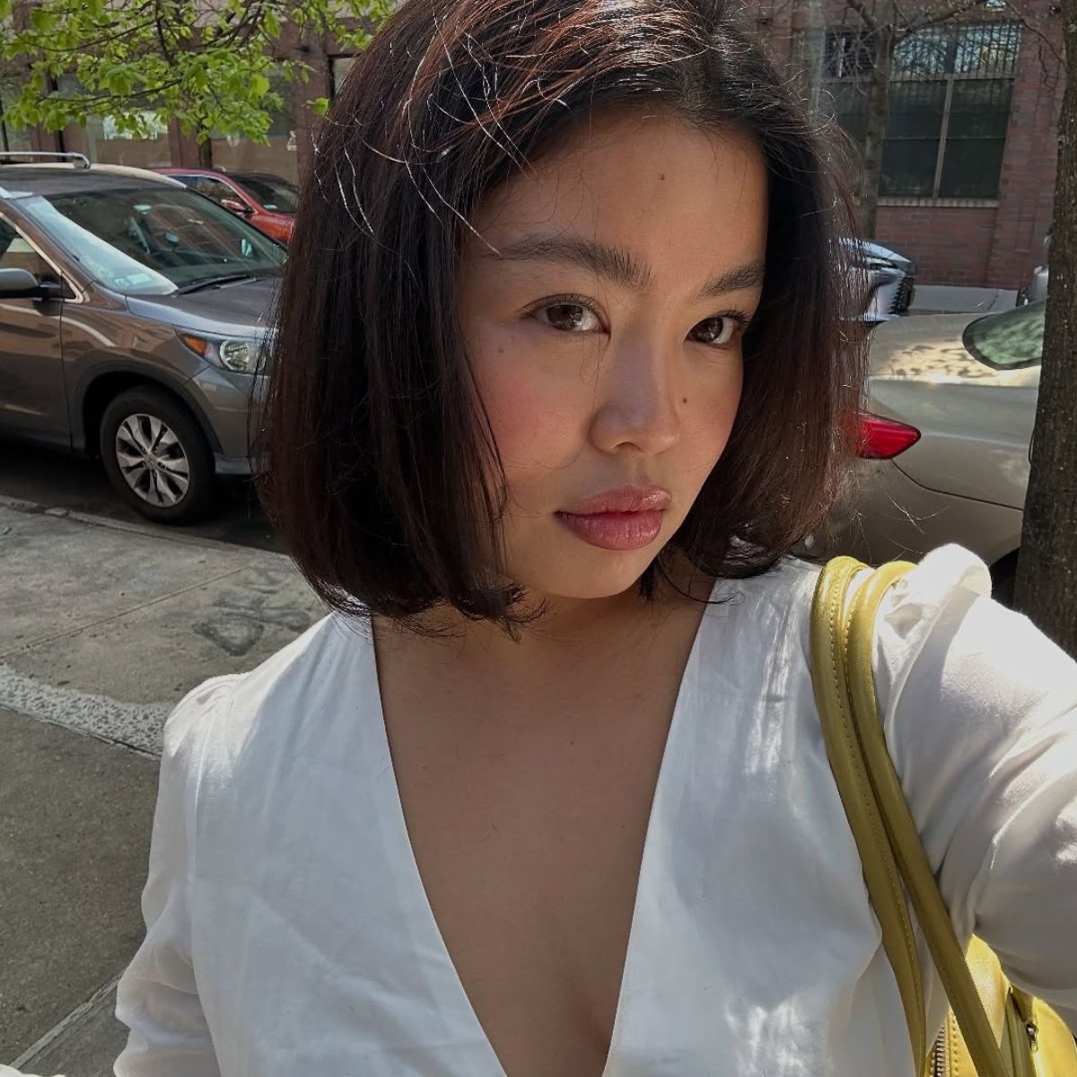 A woman taking a selfie with glowing skin