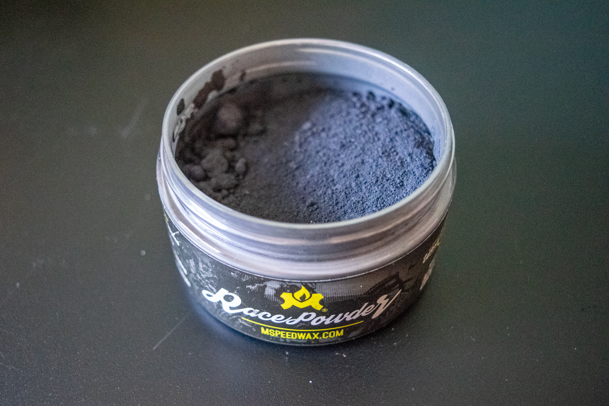 A small tub of Molten Speed Wax race powder