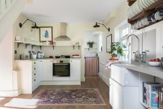 White kitchen, wooden floor, black lamps