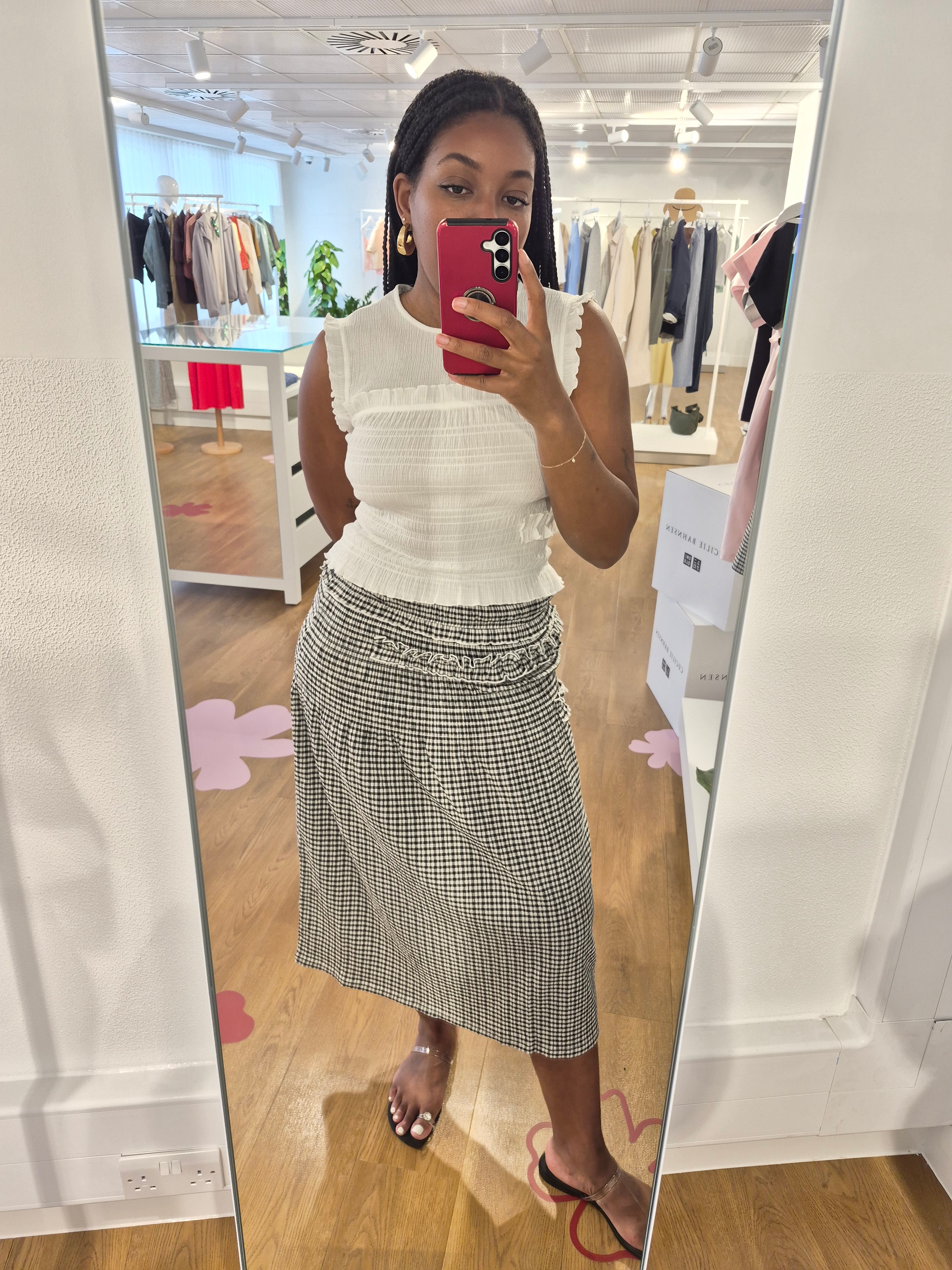 Remy is wearing a top and skirt