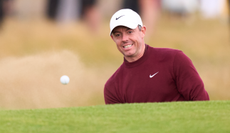 Rory McIlroy hits a bunker shot 