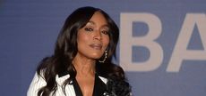 Angela Bassett wearing a white pinstripe jacket and black shirt