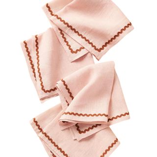 A set of pastel pink wavy bordered linen napkins