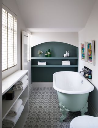 Bathroom with rolltop bath and tiles