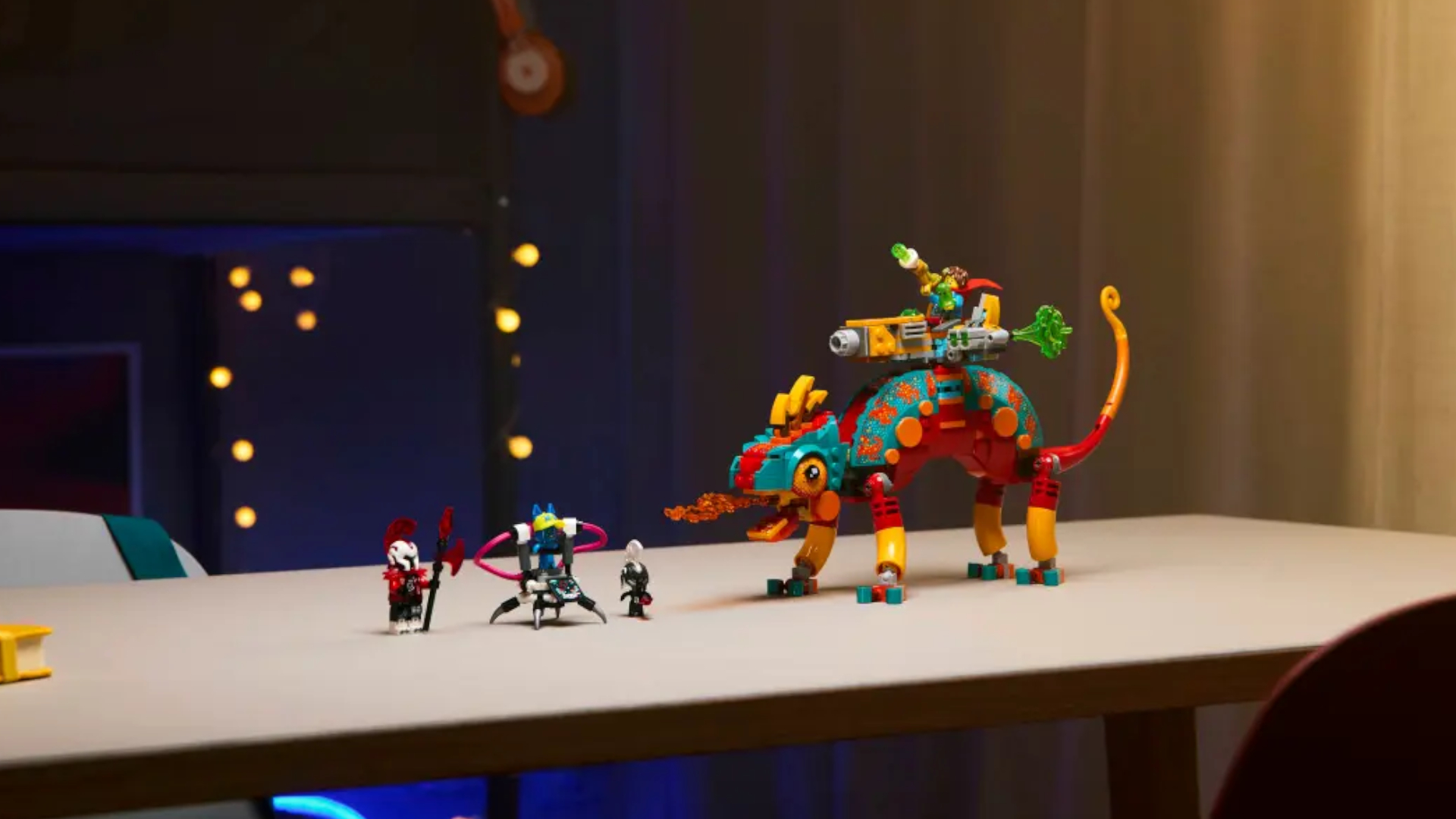 Lego Mateo&#039;s Fire Chameleon set and minifigures laid out on a plain beige table, with LED lights in the background