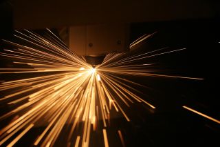 Bright sparks fly from a welding device