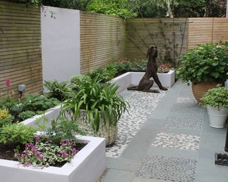 Pebble and mosaic patio area designed by Outerspace creative landscape
