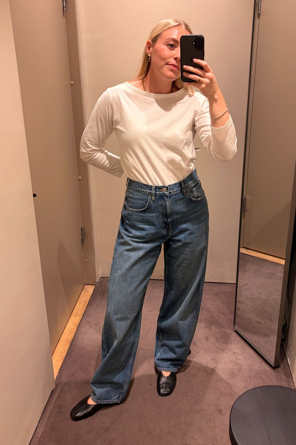 Shopping editor Florrie Alexander wears a white COS top, COS Bay Barrel Jeans, black ballet flats