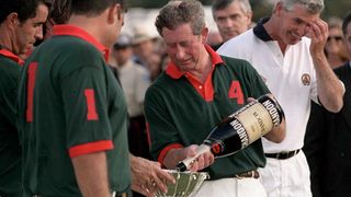 King Charles most memorable moments - Prince Charles pouring champagne in his polo trophy, he later drank from it and spilled down himself