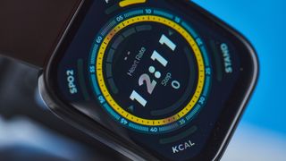 Amazfit Bip 5 showing the default yellow and blue toned watch face and fitness capabilities