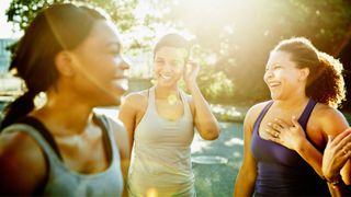 Group of women standing in a circle in the early morning about to start exercising