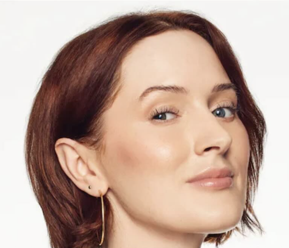a white woman with red hair and glowing skin