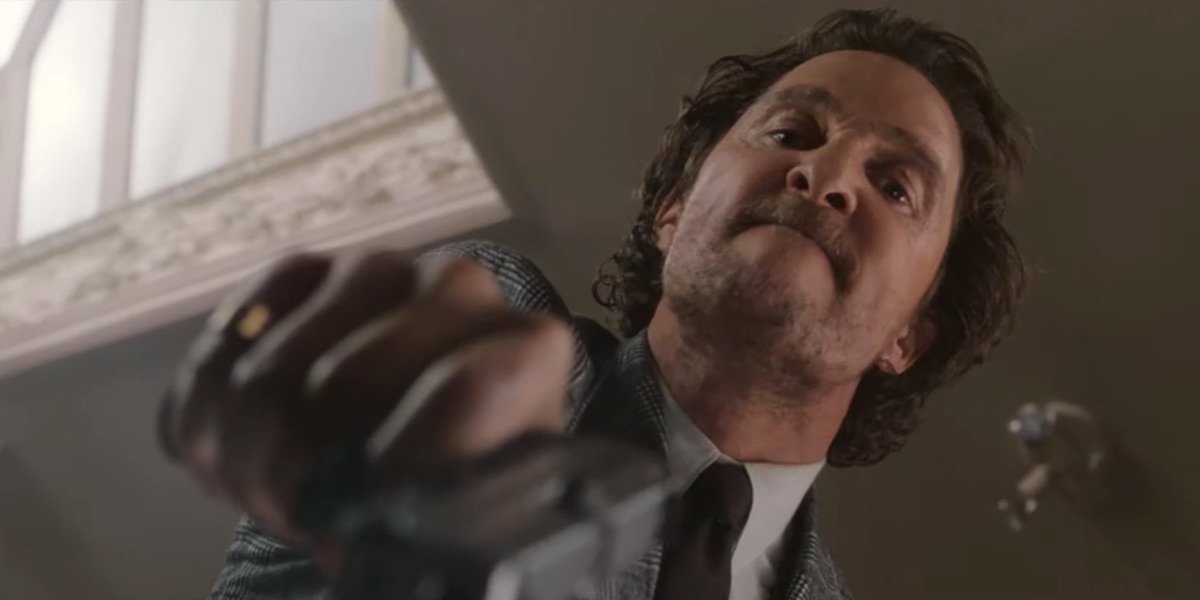 Matthew McConaughey holding gun in The Gentleman