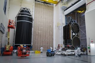 The EchoStar 23 satellite (right) is prepared for launch aboard a SpaceX Falcon 9 rocket in this prelaunch image.