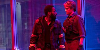 Tenet John David Washington and Robert Pattinson in a red/blue lit room