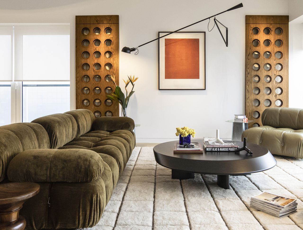 A small living room with a large green couch