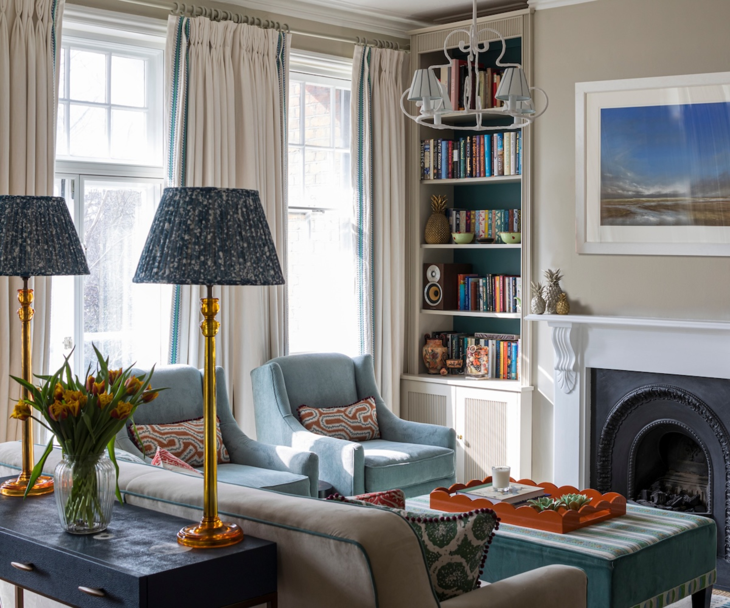 living room with blue and white colour scheme, table lamps and ceiling pendant