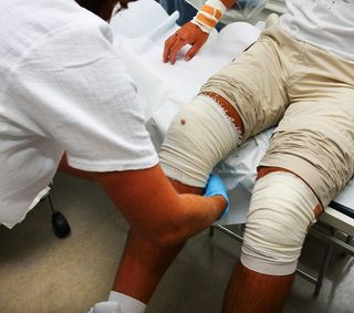 A man's leg is bandaged