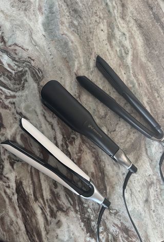 Ghd Chronos, ghd Chronos Max and GHD platinum+ hair straighteners on marble surface