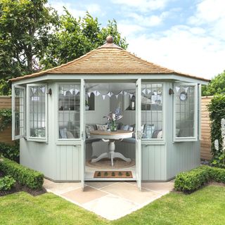 duck egg coloured summerhouse with bunting