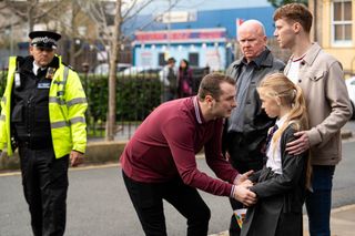 Ben Mitchell reassures Lexi Pearce as the police wait outside the Queen Vic to take him away