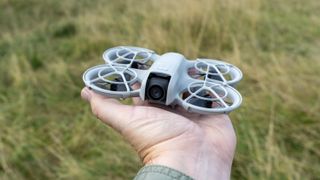 DJI Neo drone landing in a hand