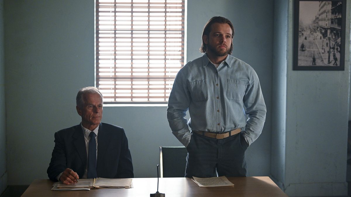 Max Thieriot as Bode Donovan standing in front of a table in Fire Country