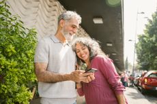 Mature Couple finding their way with the help of a smartphone