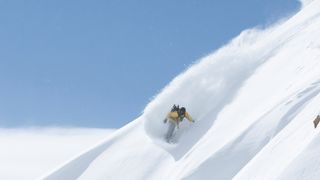 Person snowboarding on Wasatch Mountains, Utah, USA