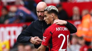 Manchester United's Brazilian midfielder Antony (R) is congratulated by Manchester United's Dutch manager Erik ten Hag (L) as he leaves the pitch during the pre-season friendly football match between Manchester United and Lens at Old Trafford stadium, in Manchester, on August 5, 2023.