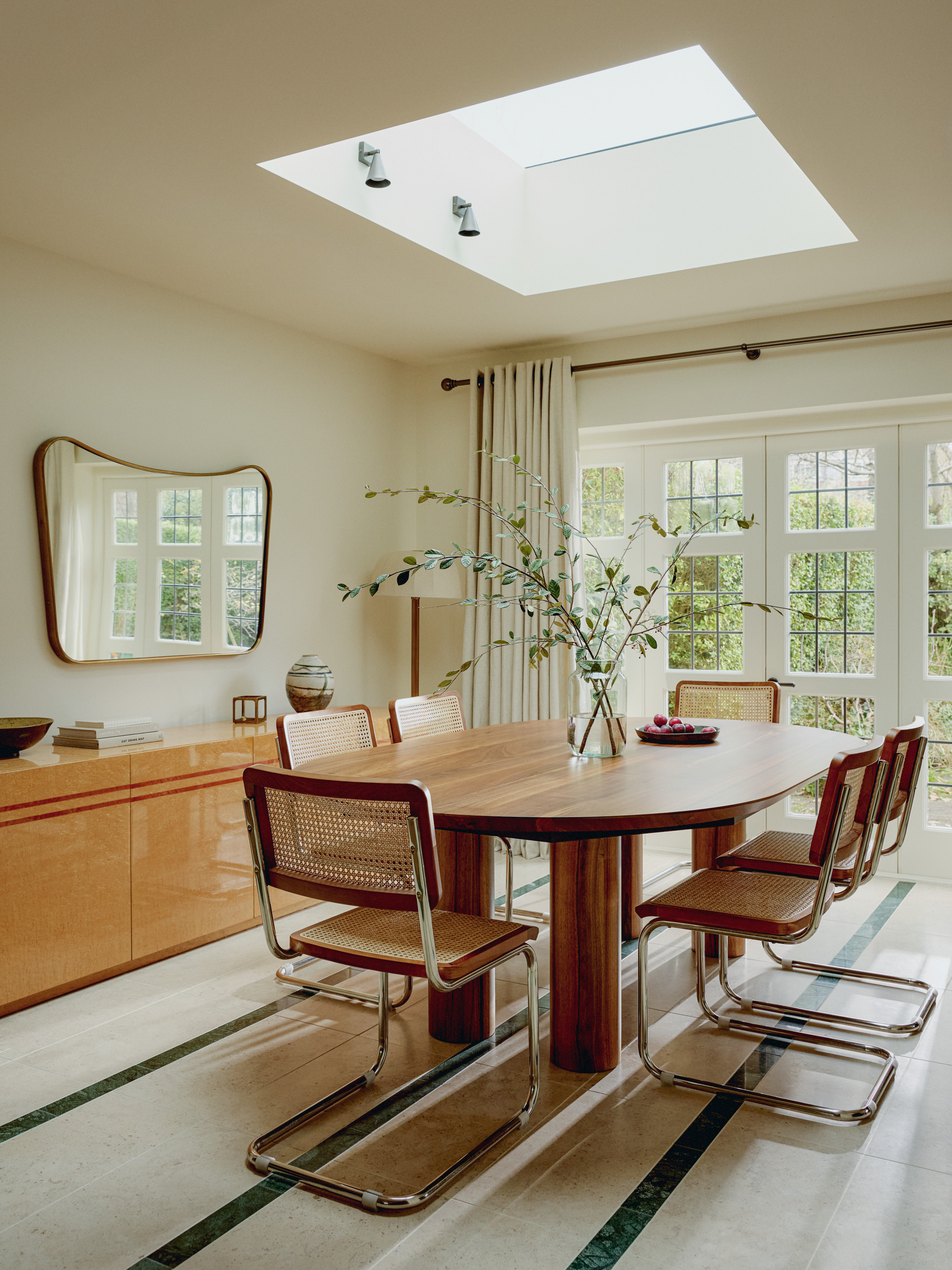 White dining room with wood table and steel chairs