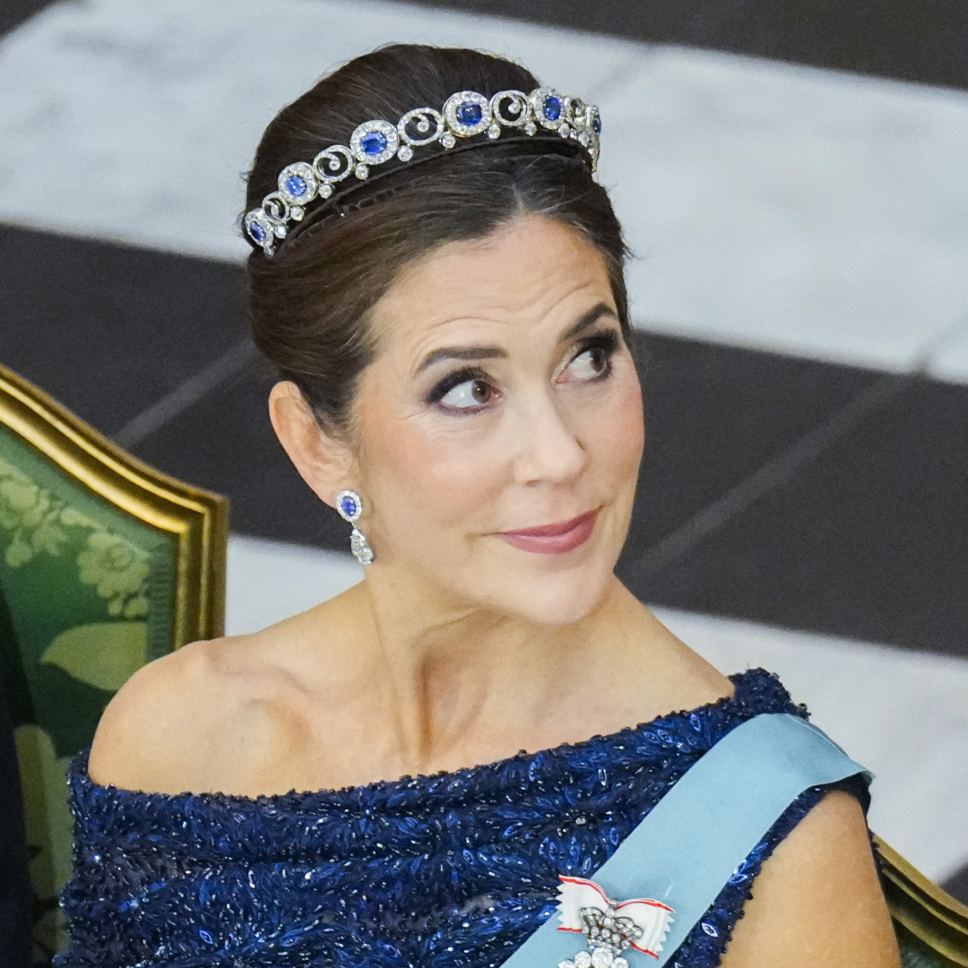 Queen Mary wearing a blue dress and sapphire tiara